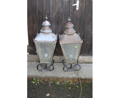 A pair of 20th century Victorian style copper finished exterior pillar lamps, each of canted square form with urn finial and 