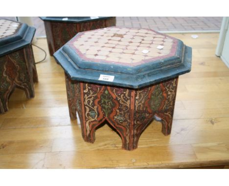 An Eastern octagonal low table, with tile worked top and painted and arcaded sides, 44cm wide