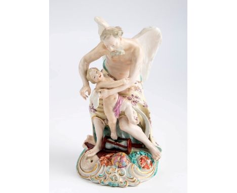 An 18th century Derby Patch figure of Father Time, modelled clipping the wings of youth, the base with crown skull, globe and