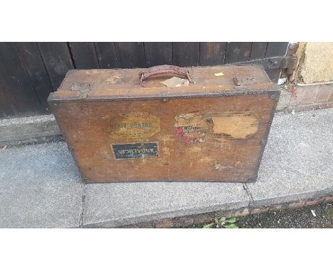 A vintage plywood suitcase with many old travel labels, 60cm