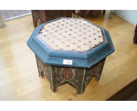 An Eastern octagonal low table, with tile worked top and painted and arcaded sides, 44cm wide