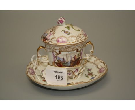 A 19th century European porcelain trembleuse chocolate cup and saucer, the dome cover with bud finial and the twin handled bo
