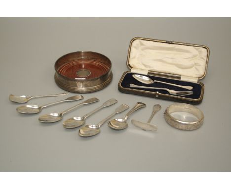 A silver wine coaster with turned wood base, a cased silver two piece christening set, four silver teaspoons, a silver bangle