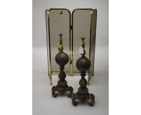 A pair of 19th century steel and brass fire dogs, each with globe shaft and a 20th century four panel smoked glass brass fram