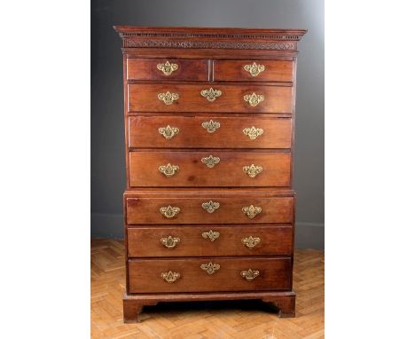 A George III mahogany chest on chest, the moulded and dentil cornice over two short and three long drawers with pierced batsw