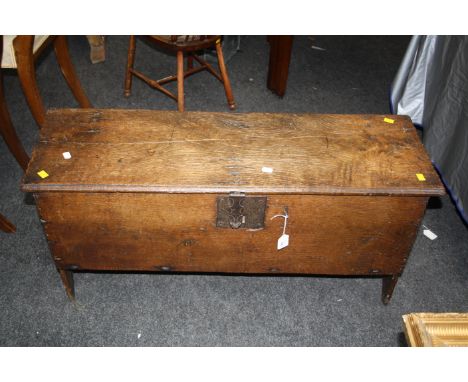 A late 17th century oak six plank coffer, with chip carved lid and vacant interior on bracket end supports, 49 x 102 x 33cm