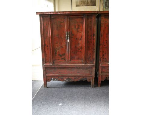 An antique timber constructed Chinese wedding cupboard, red lacquer painted with chinoiserie detail, the rectangular top over