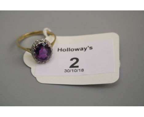 An amethyst and diamond cluster ring, the oval cut amethyst claw mounted within eight-cut diamond border to plain shank