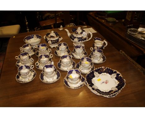 A Victorian, possibly Alcocks, extensive bone china tea set, decorated with blue and gilt borders and sprays of summer flower