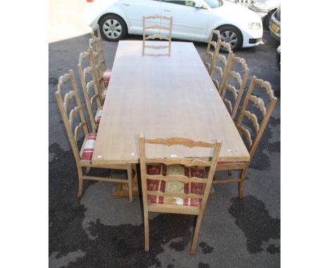 A Guha &amp; Sons of Calcutta limed wood refectory table with heart pierced stile supports, together with a set of ten matchi