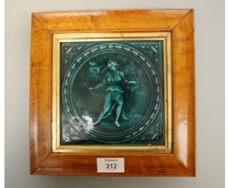 A 19th century, probably Minton majolica tile, decorated with a classical female holding flaming bowl and lightning bolts, re