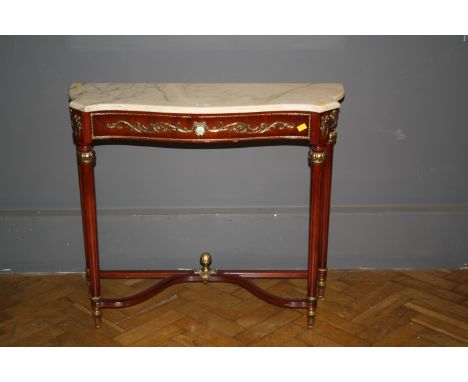 A reproduction Louis XV style console table, the serpentine marble top over gilt decorated frieze on turned fluted legs unite