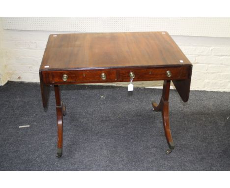 A George III inlaid mahogany sofa table, with two frieze drawers, raised on splay supports with brass socket castors, 92cm wi