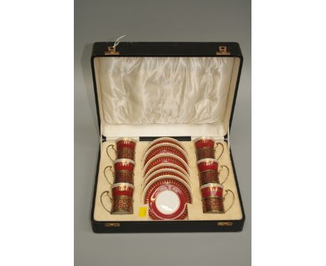 A cased set of six George V Spode coffee cans and saucers, Ryde pattern, the cans with pierced silver gilt coasters, hallmark