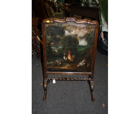 A late 17th century style walnut fire screen, with painted panel, raised on shaped supports, 57cm wide