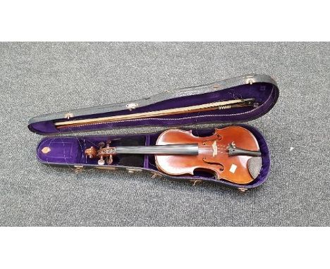 A student's full size violin, bow and rexine covered hard case, the violin bearing a Stradivarius copy label, 36.7cm length o