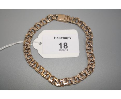 A flattened triple link bracelet with push button clasp, marked '585'