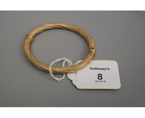 A 9ct gold textured rope twist bangle, with sprung hinge and concealed clasp
