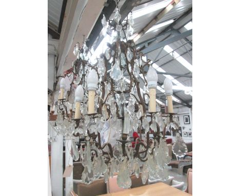 CHANDELIER, having eight metal branches with cut glass droplets, hung 54cm W x 95cm H. (with faults)