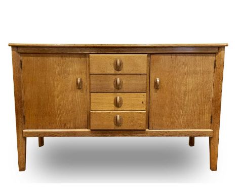 A Gordon Russell Limited oak sideboard, with four central drawers flanked by two cupboard doors, label to the back 'Gordon Ru