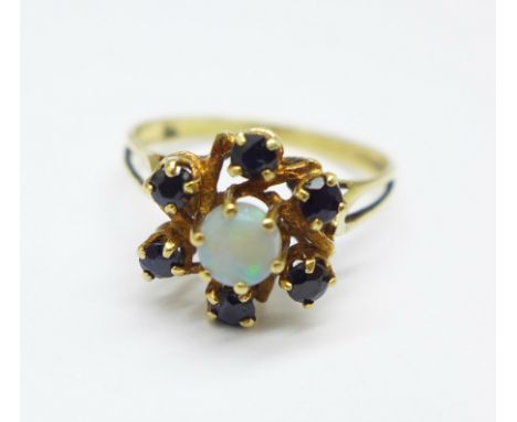 A yellow metal dark sapphire and opal cluster ring, with control marks on the outside of the shank, 2.4g, P 