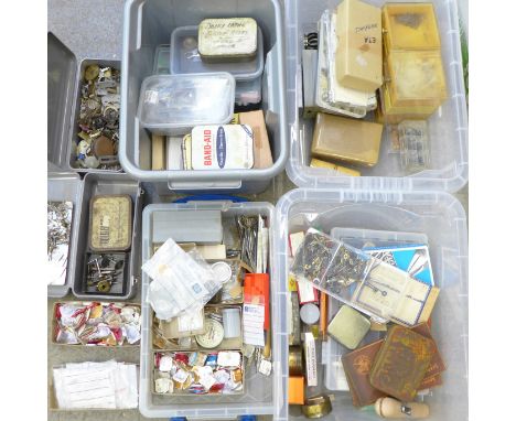 A large collection of watch parts and some tools including watchmaker's tweezers 