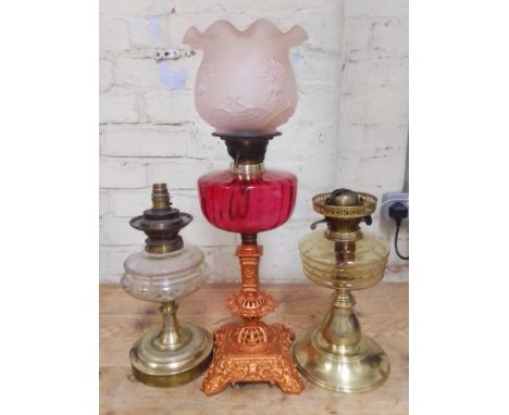 A group of three oil lamps. .(one has been converted to electric)Condition:- General wear through age and use, one with clear