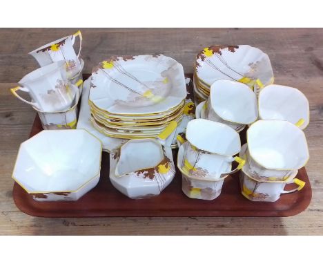 A Shelley Sunrise and Tall Trees Art Deco tea service, 40 pieces.Quantity:- 12 x trios, 1 x sugar bowl, 1 x cream jug, 2 x la