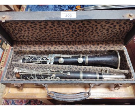 A rosewood clarinet marked 'France' and 'New Brunswick'. 