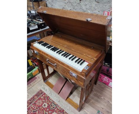 A Pearl River portable organ/harmonium in oak case, width 79cm. 