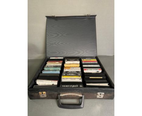 A cased of vintage cassettes to include David Bowie, The Police and The Beatles 