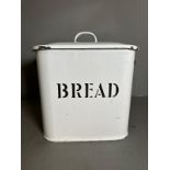 A vintage white enamel bread bin