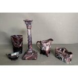 A selection of Sowerby purple glass items to include candle stick, milk jug and a salt