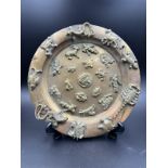 An Indian brass "Deity" plate decorated with various brass animals