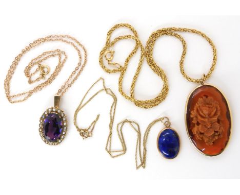A yellow metal mounted carved amber pendant with a 9ct decorative rope chain, length 42cm, together with a lapis lazuli penda