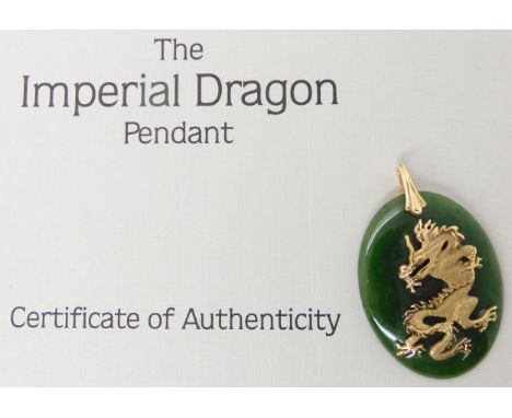 A Guildmark products green jade and 18ct gold imperial dragon pendant with certificate, weight approx 13gms Condition Report: