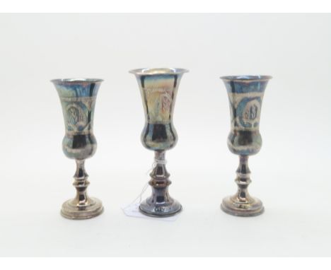 A pair of silver Kiddush wine cups, with engine turned decoration, by&nbsp;J Zeving (or Joseph Zweig), Chester 1920, and anot