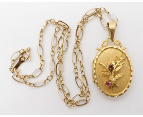 A 9ct decorative locket and chain, the locket set with rubies. Length with bail 4cm, length of chain 41cm, weight 10.1gms Con