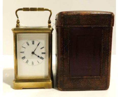 A French brass and glass carriage clock, with travelling case and key Condition Report:winds and ticks