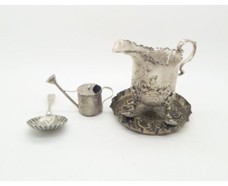 A silver cream jug, with chased and applied decoration of rabbits and birds, with scrolling rim and s shaped handle, by Georg