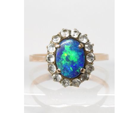 A yellow metal opal doublet and clear gem cluster ring, size Q, weight 2.4gms Condition Report:Available upon request