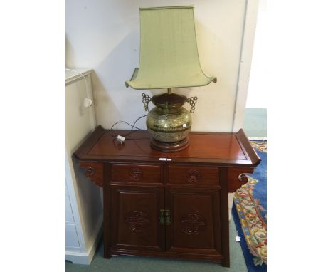 A 20th century hardwood Oriental style cabinet with two drawers above two cabinet doors, 84cm high x 102cm wide x 41cm deep a