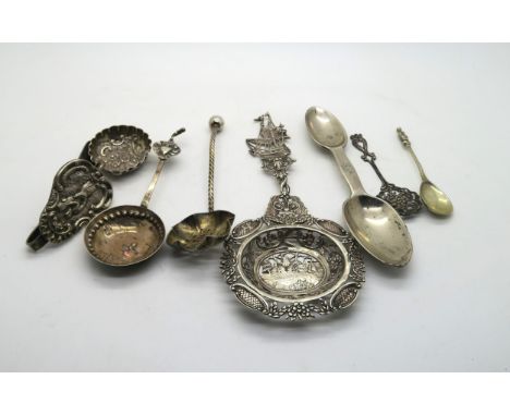 A collection of silver including a silver strainer spoon with pierced and engraved decoration of windmills, with a ship finia