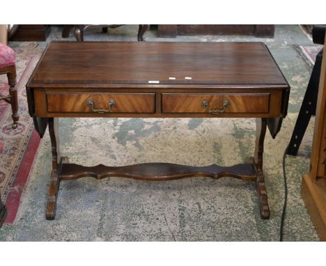 A reproduction mahogany sofa table, shaped drop leaves, two short drawers to frieze, shaped undertier.