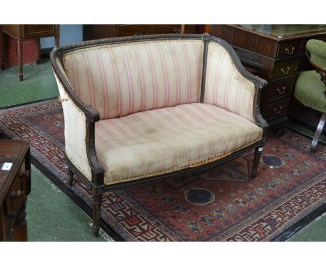 An early Victorian mahogany sofa of small proportions, carved back rail, upholstered back and seat, tapering, fluted legs, c.