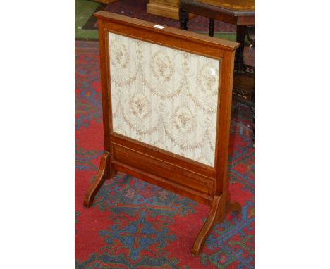 An Arts and Crafts mahogany fire screen, the needlework banner in coloured silks with birds amongst fruiting branches, c.1910