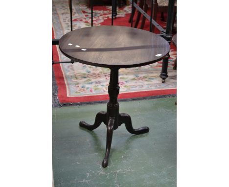 A circular mahogany tripod table. 71cm high x 87cm diameter.