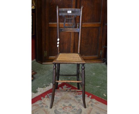 A Victorian oak and beechwood correction chair, lyre-form splat, bobbin-turned legs and stretchers, woven reed seat, c.1870..