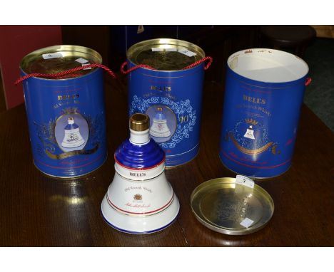 A Bells Scotch Whisky decanter and contents, celebration Royal Family, cylindrical box; two others similar (3)