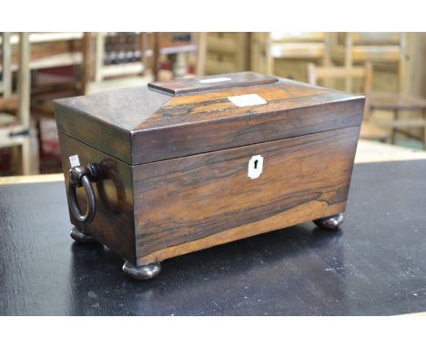 A 19th century rosewood sarcophagus shape tea caddy, part fitted, ring handles, mother-of-pearl escutcheon, bun feet, 30cm wi